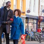 Mature black couple enjoying shopping together in UK high street