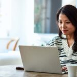 Woman using laptop and working from home