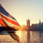 British union jack flag and Parliament house at city of Westminster in the background