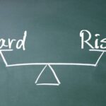 Chalkboard representation of risk versus reward on a pair of scales